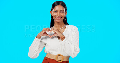 Buy stock photo Business woman, heart hands and face in studio, blue background and love emoji sign. Portrait, female person and model with thank you and a smile with hope and happy from career trust and job