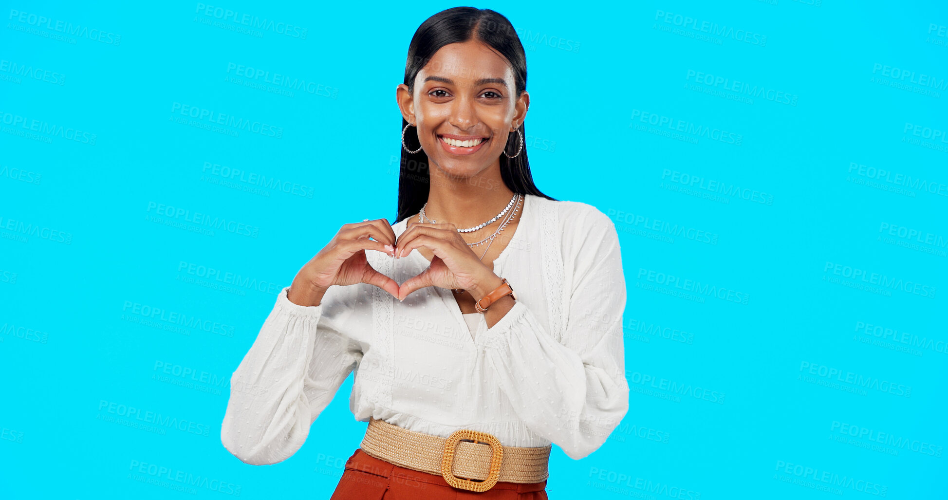 Buy stock photo Business woman, heart hands and face in studio, blue background and love emoji sign. Portrait, female person and model with thank you and a smile with hope and happy from career trust and job