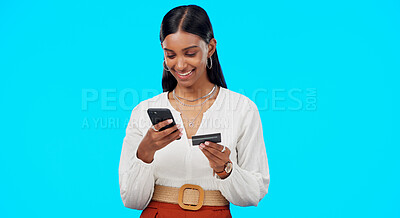 Buy stock photo Happy woman in studio with phone, credit card and online shopping, banking or payment. Ecommerce, financial freedom and girl with smile on smartphone app for cashback or search on blue background.
