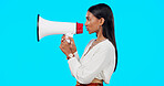 Megaphone, voice and announcement of woman isolated on blue background broadcast, breaking news and loud opinion. Indian person with speaker sound for gen z lifestyle or call to action sign in studio