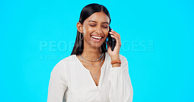 Buy stock photo Happy woman, phone call and laughing for funny joke, conversation or meme against a blue studio background. Friendly female person or employee smile for fun discussion on mobile smartphone on mockup