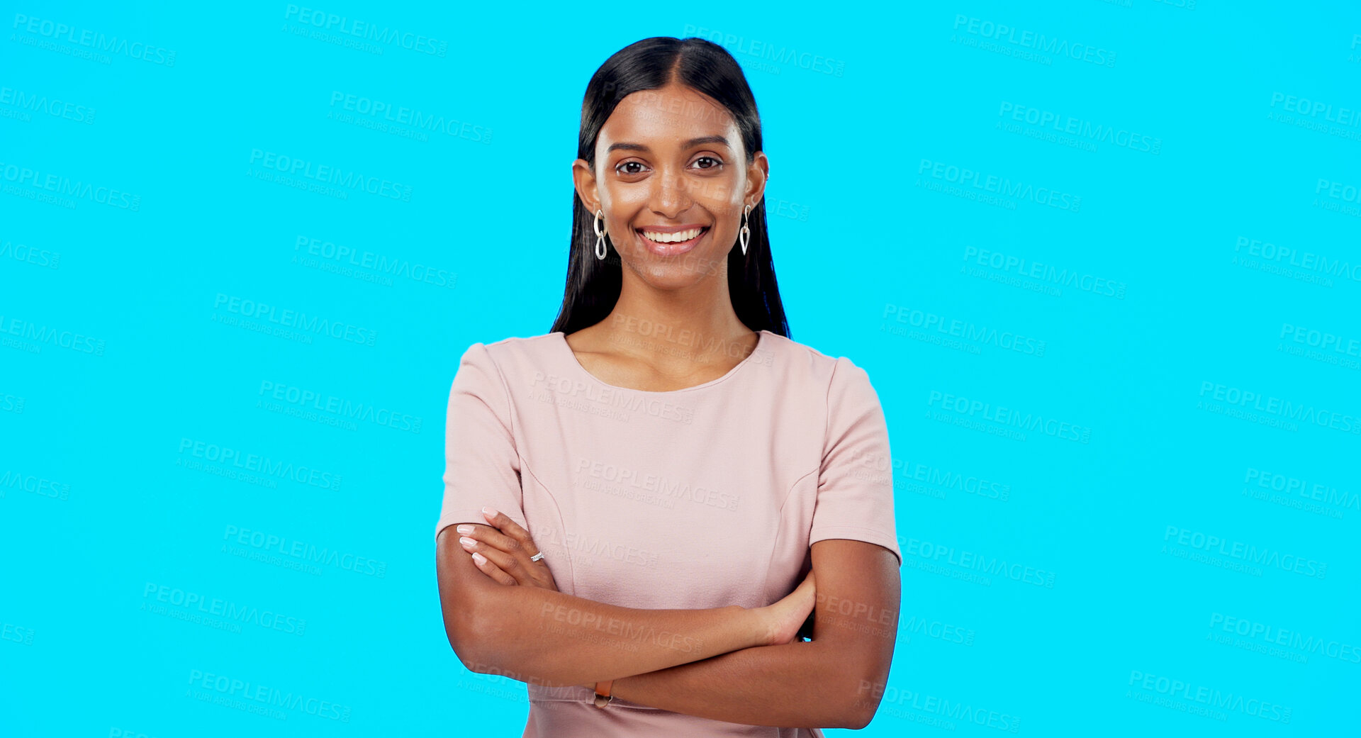 Buy stock photo Crossed arms, business and portrait of happy Indian woman in studio for career, job and work opportunity. Professional, confidence and face of person on blue background with pride, ambition and smile