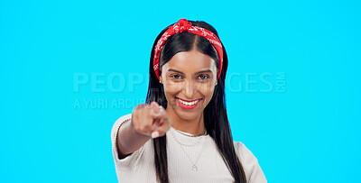 Buy stock photo Portrait, woman in studio and pointing for recruitment, decision or choice in support for vote. Smile, motivation and opportunity, gen z girl with trust and opinion for inspiration on blue background