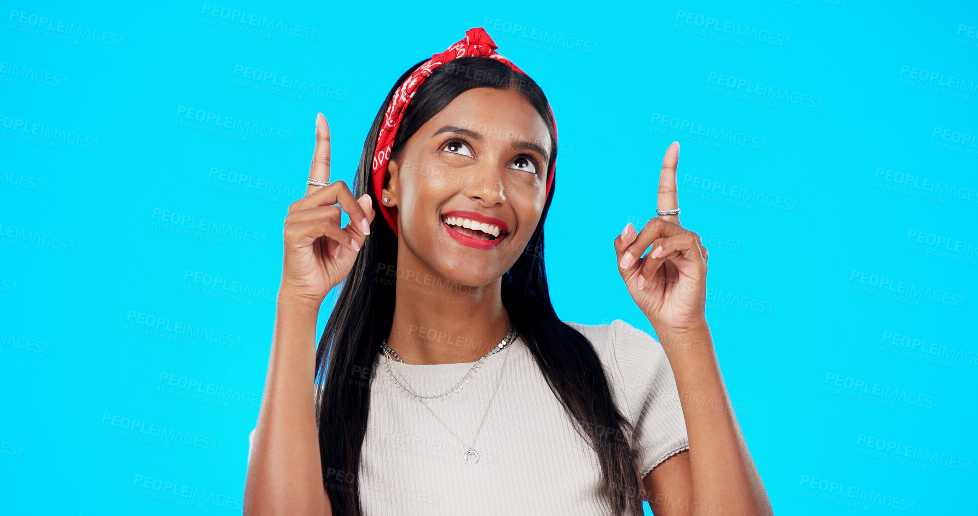 Buy stock photo Studio face, smile and woman point at advertising news, commercial promotion or branding offer, service or direction. Information, sales discount and Indian person announcement on a blue background