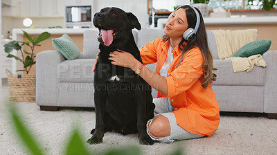Black dog scratch, woman and living room with animal and pet owner care in a home. Headphones, gen z person and labrador in a house with happiness and a smile listening to music with puppy love