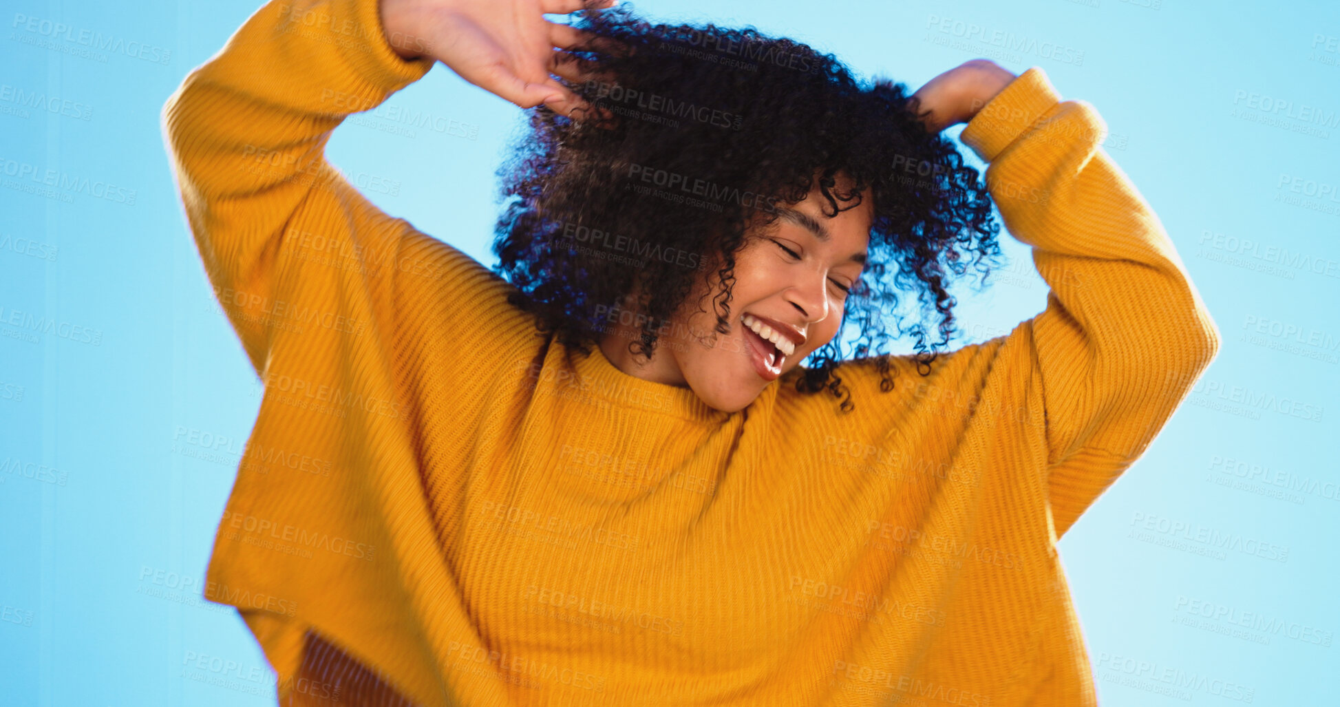 Buy stock photo Happy black woman, dance and beauty in studio by blue background for fashion, smile or wellness. Young gen z student, dancing and freedom with yellow clothes, curly hair afro and energy on backdrop