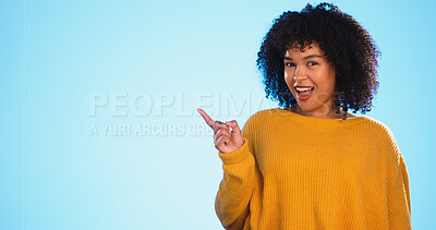 Buy stock photo Woman, pointing at mockup for advertising or promotion in studio, portrait with information and news on blue background. Announcement, marketing and about us with launch presentation and platform