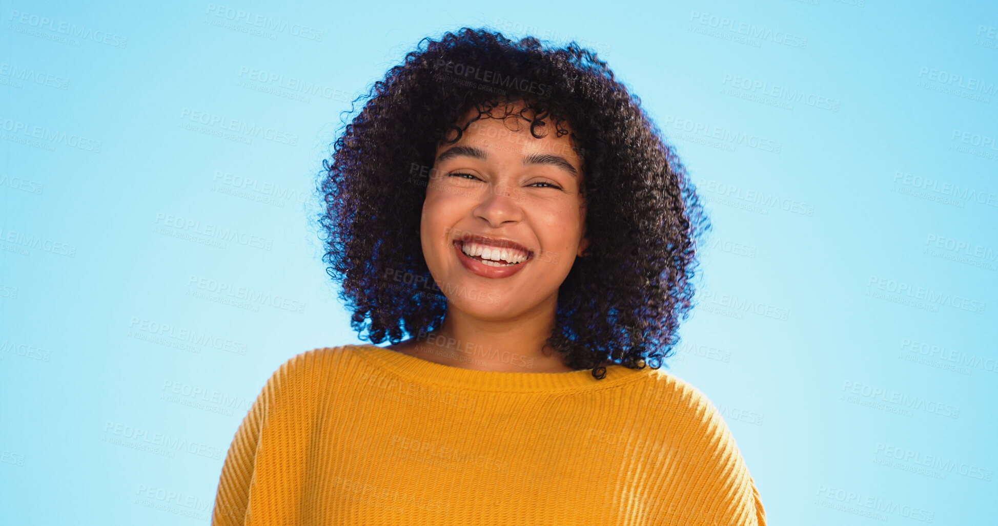 Buy stock photo Face, funny and woman with smile, excited and cheerful in studio isolated on a blue background mockup space. Portrait, African model and happy person laughing in clothes for fashion, style and trendy