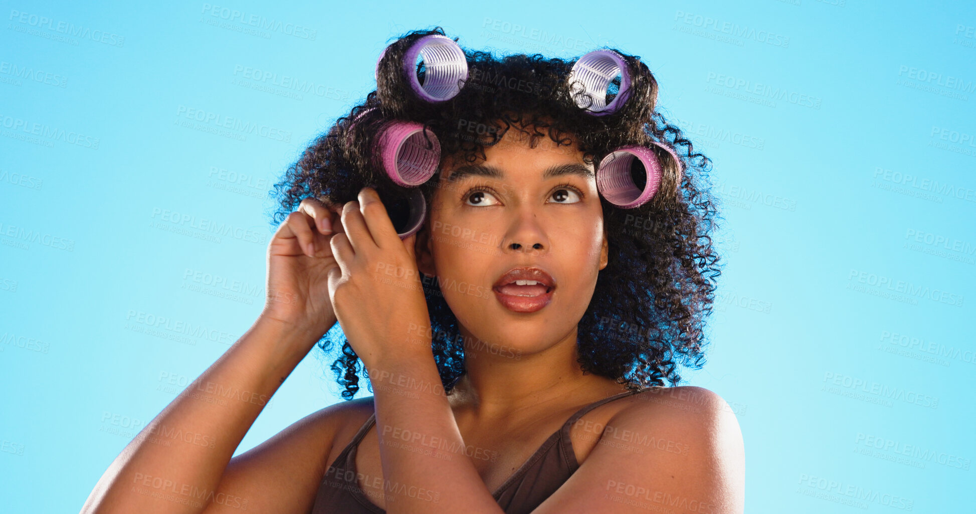 Buy stock photo Thinking, woman and roller for hair in studio isolated on a blue background for healthy haircare. Curlers, hairstyle and African model at hairdresser salon for wellness, cosmetics treatment or beauty