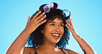 Afro, smile and black woman with roller for hair on blue background for curly, natural and hairstyle. Beauty salon, hairdresser and happy girl with accessory for wellness, grooming and cosmetics