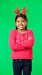 Christmas, smile and happy with girl in green screen studio for positive, celebration and festive. Present, cheerful and vacation with portrait of child on background for season, holiday or happiness