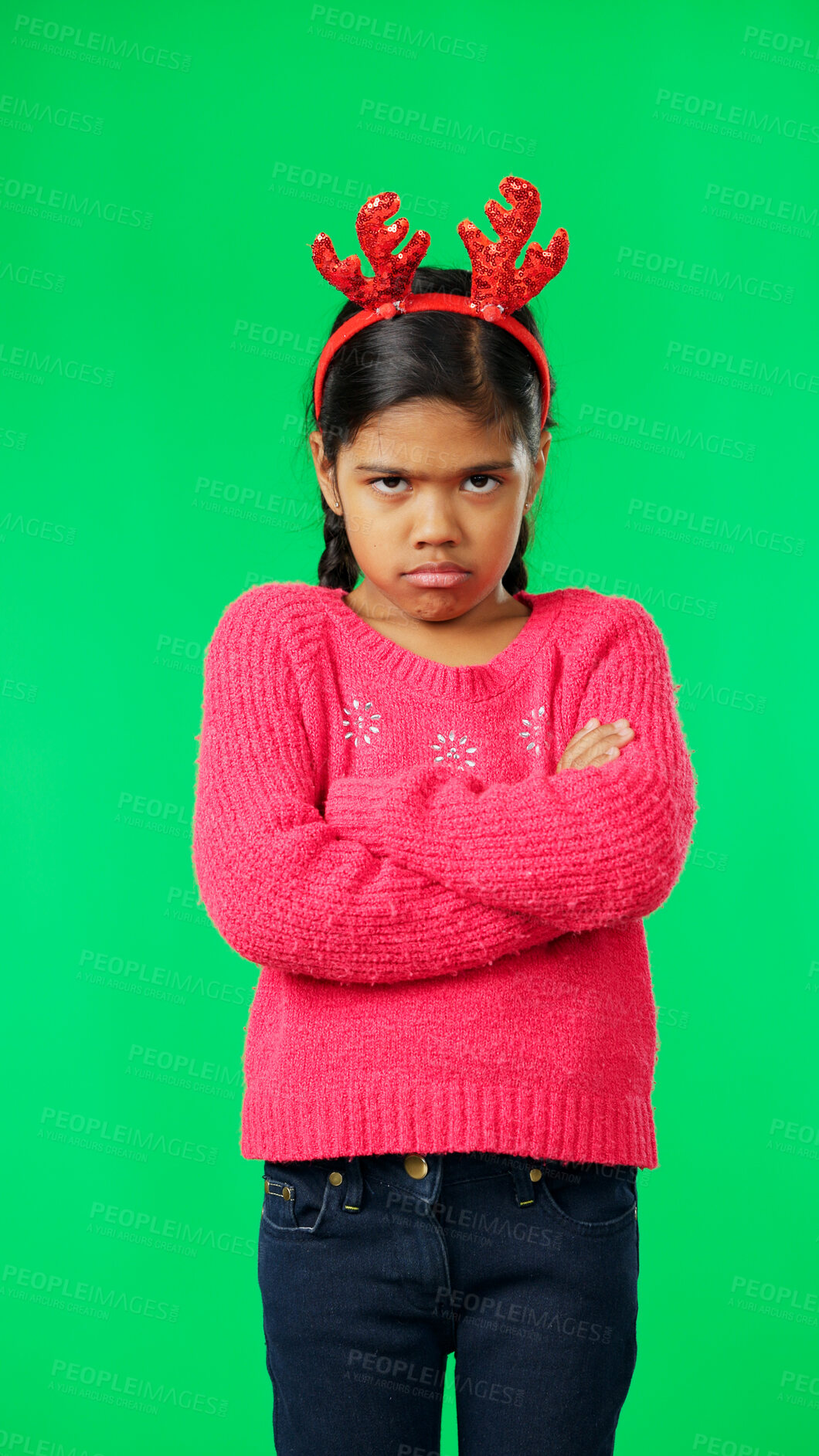 Buy stock photo Portrait, christmas and unhappy girl, green screen and standing with arms crossed, angry or sad. Child, frustrated  and miserable with antlers headband, moody and annoyed for festive, tantrum, or mad