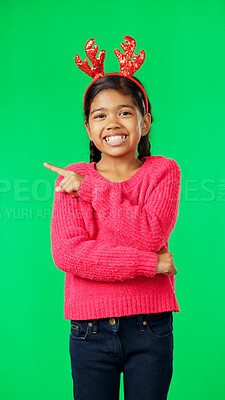 Buy stock photo Christmas portrait, green screen or happy child pointing at festive holiday, celebration news or event information. Advertising direction, promo or young girl, kid or youth smile on studio background