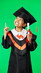 Graduation, education and child point on green screen for graduate, academy ceremony and award. Primary school, student and portrait of happy girl with knowledge, achievement and success in studio