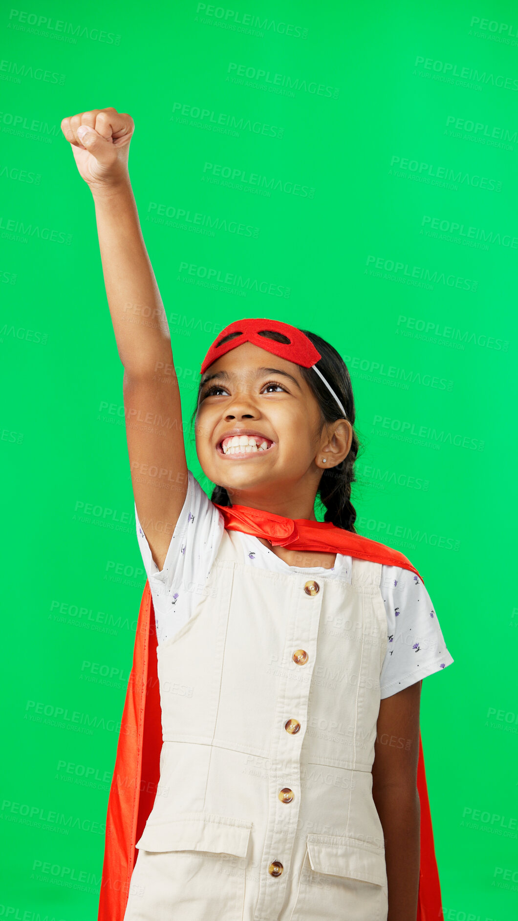 Buy stock photo Superhero, pointing and excited flying game of child on green screen for fantasy, cosplay costume and comic character. Girl, justice cape and mask of kid in studio for freedom with a smile and happy