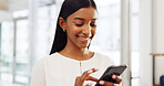 Happy Indian woman on her phone, social media or online search looking at viral videos at home. Young girl on mobile, smartphone or cellphone on an app, reading chat or internet web scrolling.