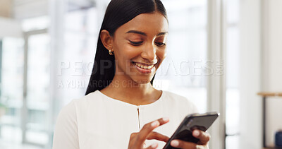Happy Indian woman on her phone, social media or online search looking at viral videos at home. Young girl on mobile, smartphone or cellphone on an app, reading chat or internet web scrolling.