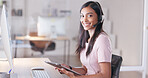 Portrait of a young female customer service agent working in ecommerce and sales. Business woman working on a tablet in her office while helping and assisting customers online with IT support