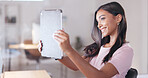 Young happy woman taking a selfie with a digital tablet while relaxing in an office at work. One smiling female student taking pictures to post on social media while sitting alone in a library