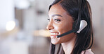 Call center agent helping client in a phone call giving great customer service. Customer support employee consulting clients online using headset. Professional friendly woman working at her desk