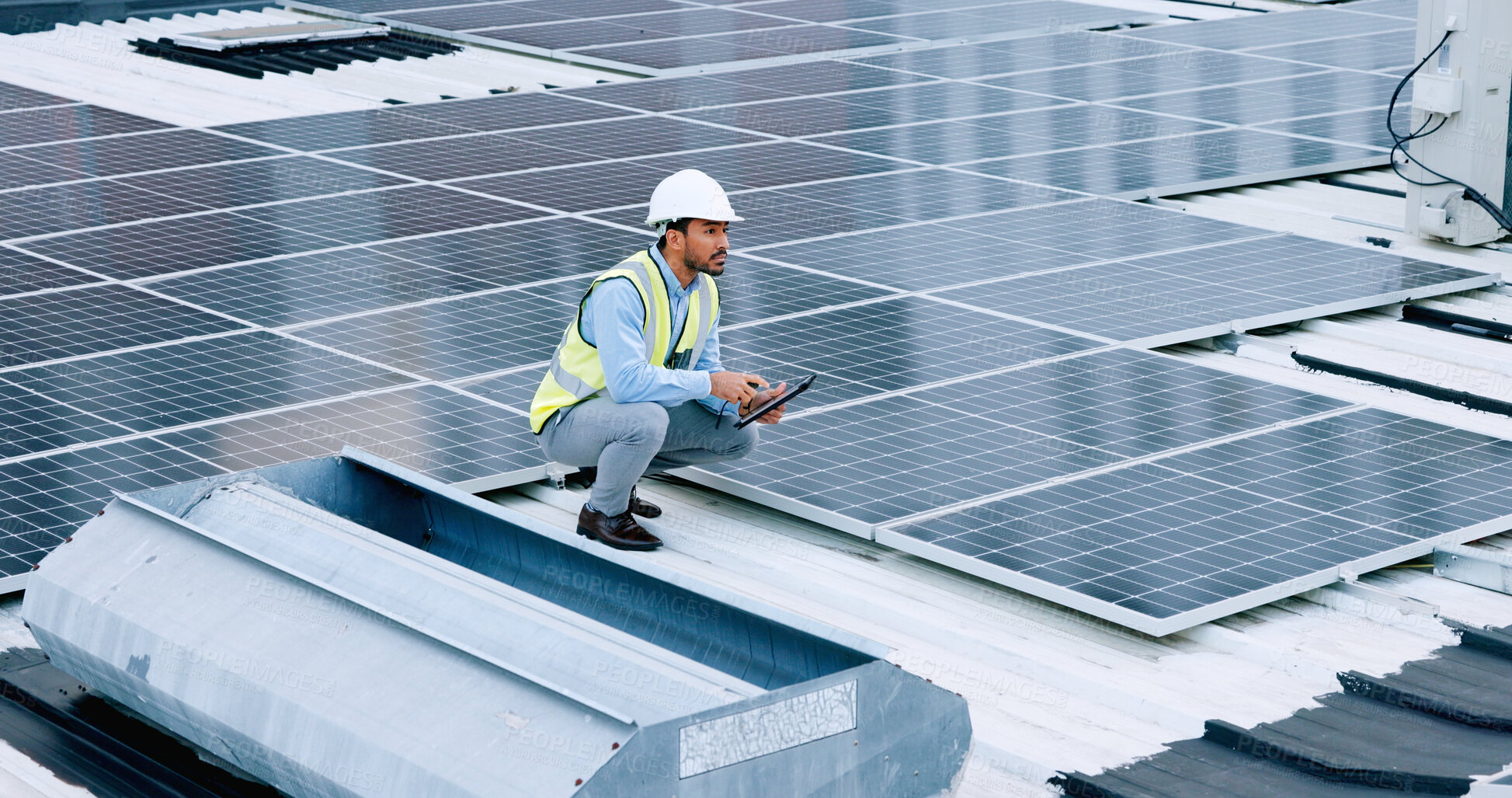 Buy stock photo Engineer, contractor and solar panel above with a man on roof with sustainability project. Engineering technician, green clean energy and eco friendly work with monitoring and maintenance for job 