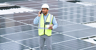 Ambitious, happy and confident solar power installer, engineer and electrician talking on a phone while discussing blueprint plans for construction, building and maintenance of renewable energy