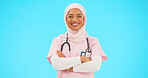 Muslim woman, face and nurse smile with arms crossed in studio isolated on blue background mockup. Portrait, medical professional and confident, happy and proud Islamic person or surgeon from Turkey.