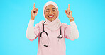 Muslim nurse, happy woman and pointing finger portrait with space for healthcare, religion or happiness. Islamic female medical worker with hand, smile and hijab for announcement on blue background