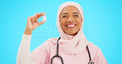 Buy stock photo Muslim woman, doctor and studio portrait for vaccine, dengue fever and smile for wellness by blue background. Islamic person, nurse and bottle for pharmaceutical product, medicine or drugs for health