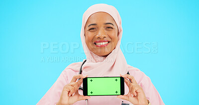 Buy stock photo Phone, doctor and face of Muslim woman with green screen in studio for healthcare, medicine and care. Mockup, nurse and portrait of person on smartphone for telehealth mobile app on blue background