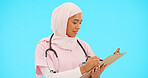 Woman, doctor and writing on clipboard in studio for information or medical record. Islamic or muslim female and professional nurse in hijab with list for healthcare insurance on blue background
