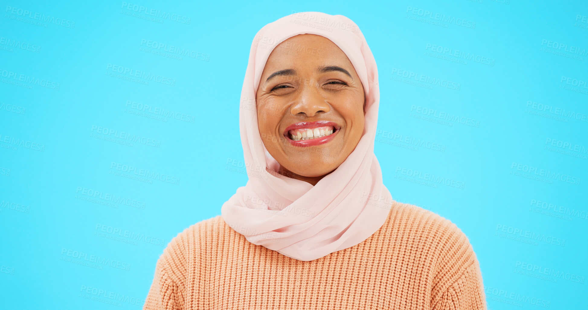 Buy stock photo Muslim woman, smile and happy portrait with advertising for eid mubarak, ramadan fashion and beauty. Islamic female, model and makeup with hijab, aesthetic and advertisement in blue studio background