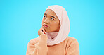 Muslim woman, thinking and idea with hand on face for mockup, advertising or thought. Serious islamic female with hijab and emoji for doubt, sad and to think about option on a studio blue background