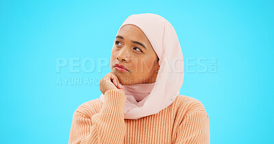 Buy stock photo Muslim woman, thinking and idea for mockup, advertising and thought. Serious islamic female, hijab and emoji for doubt, confusion and options for choices, isolated and on a blue studio background