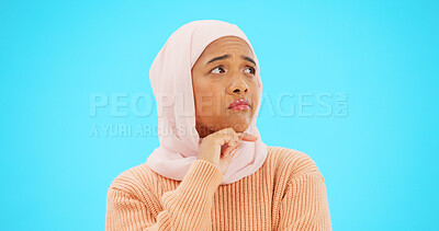 Buy stock photo Muslim woman, thinking and idea with hand, face and mockup for advertising or thought. Confused, female and hijab for doubt emoji, sign and think about option and choice on studio blue background