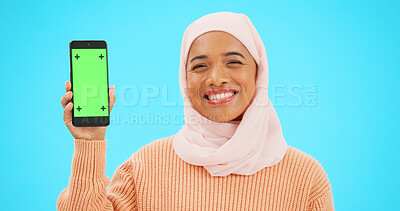 Buy stock photo Islamic girl, green screen phone and studio for smile, review or mockup space by blue background. Muslim person, smartphone and chromakey for choice, promotion or portrait with mobile app logo for ux