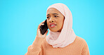Muslim woman, phone call and angry, argument or conflict in studio isolated on a blue background mockup. Cellphone, discussion and frustrated Islamic person talking, upset and speaking or question.