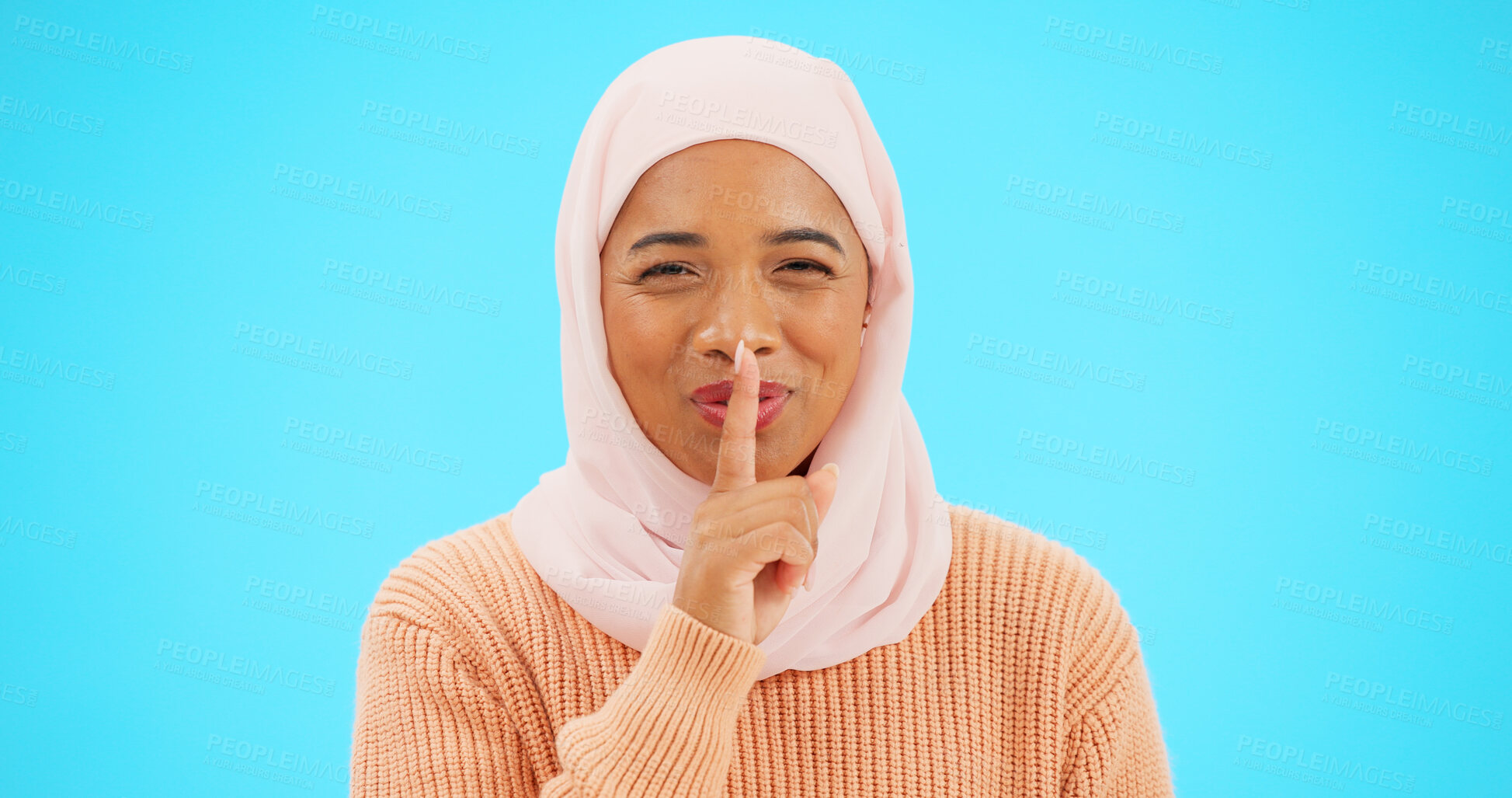 Buy stock photo Muslim, woman and whisper with secret in portrait on blue background, studio and promotion announcement. Islamic, face and girl with hijab and emoji for surprise, gossip or confidential information