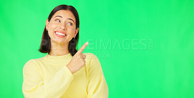 Buy stock photo Happy woman, pointing and advertising space on green screen for information, sales deal or promotion on studio background. Model show presentation of mockup, feedback or announcement of news about us
