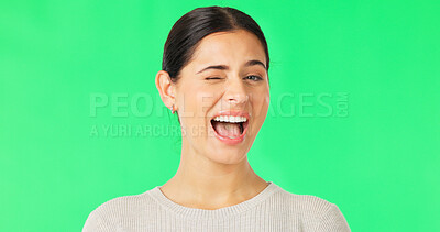 Buy stock photo Wink, woman and portrait on green screen with smile for confident personality, expression and funny joke on studio background. Happy young model blink for secret, good mood and emoji for flirting