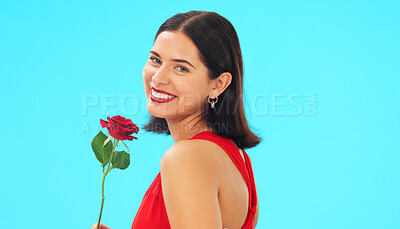 Buy stock photo Portrait, rose and woman in studio on blue background with fresh, floral or romantic gesture on mockup. Mockup, flower and female with gift, present and romance, valentines or care offering on a date