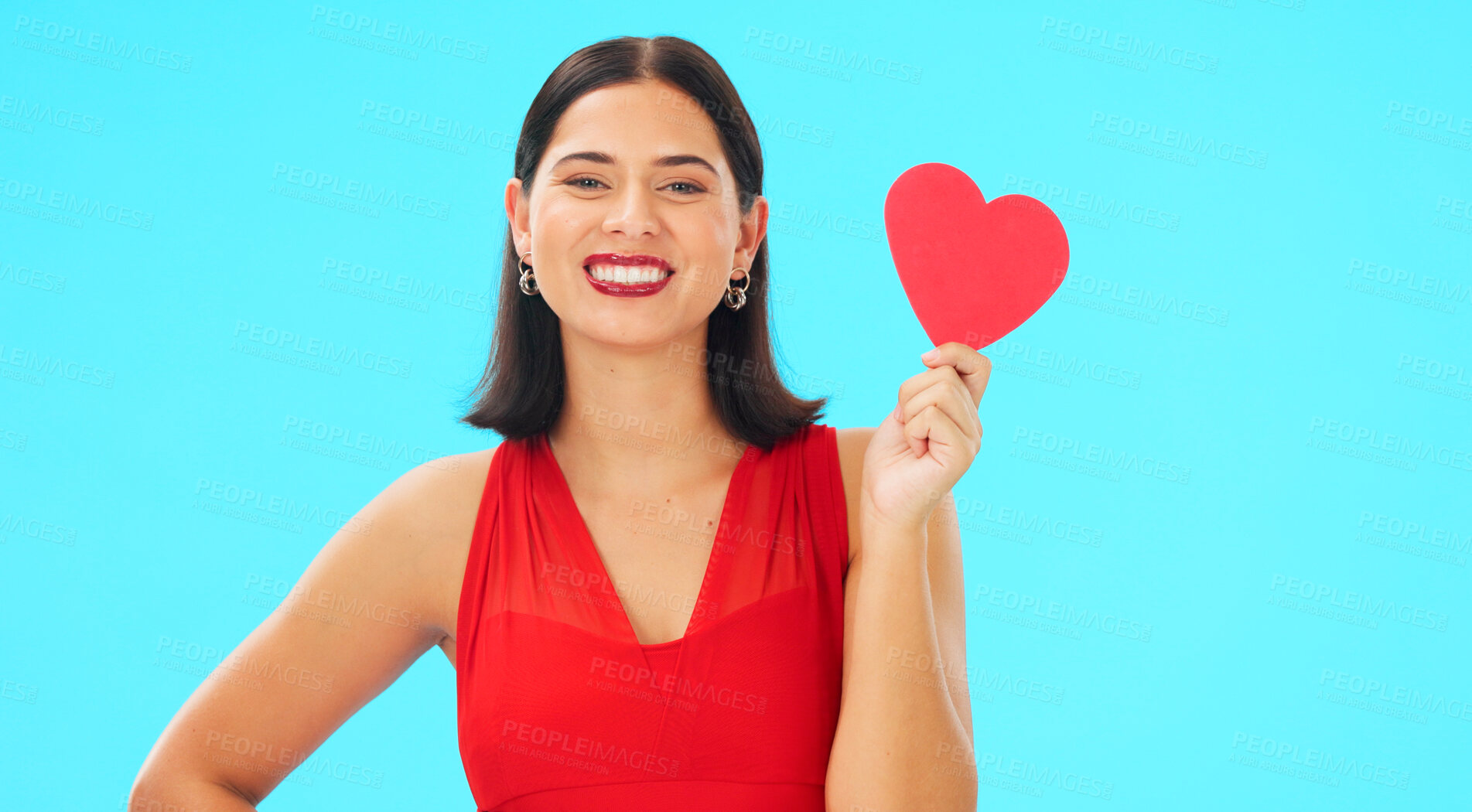 Buy stock photo Portrait, smile and woman with paper heart in studio isolated on a blue background mockup space. Face, romance and happy model with love sign for anniversary, emoji and valentines day gift or present