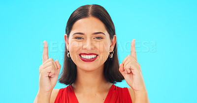 Buy stock photo Smile, portrait and woman on blue background pointing up to deal on mockup space isolated in studio. Face of model, hands sign and advertising promotion, marketing presentation and commercial offer