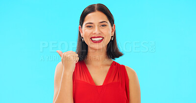 Buy stock photo Woman, point and valentines day in studio portrait for direction, suggestion or review by blue background. Girl, direction and ideas with feedback, sign or promotion for makeup, announcement or smile