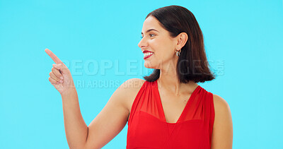 Buy stock photo Mock up, pointing or happy woman in studio for product placement space isolated on a blue background. Smile, sales deal or profile of lady showing logo for advertising, marketing or choice or option