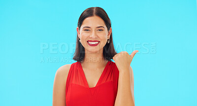 Buy stock photo Woman, face and thumbs up with beauty, smile and showing mockup for advertisement. Portrait, happy and blue studio background with success and mockup for product placement, winning or achievement