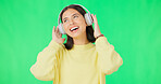 Face, green screen and woman with headphones, listen and movement on a studio background. Portrait, female dancer and person with headset, streaming music and excitement with stress relief and relax