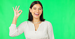 Ok hands, face and happy woman on green screen, background and studio in agreement of support. Portrait of female model, smile and okay for success, yes and winner of perfect emoji, thank you or hope