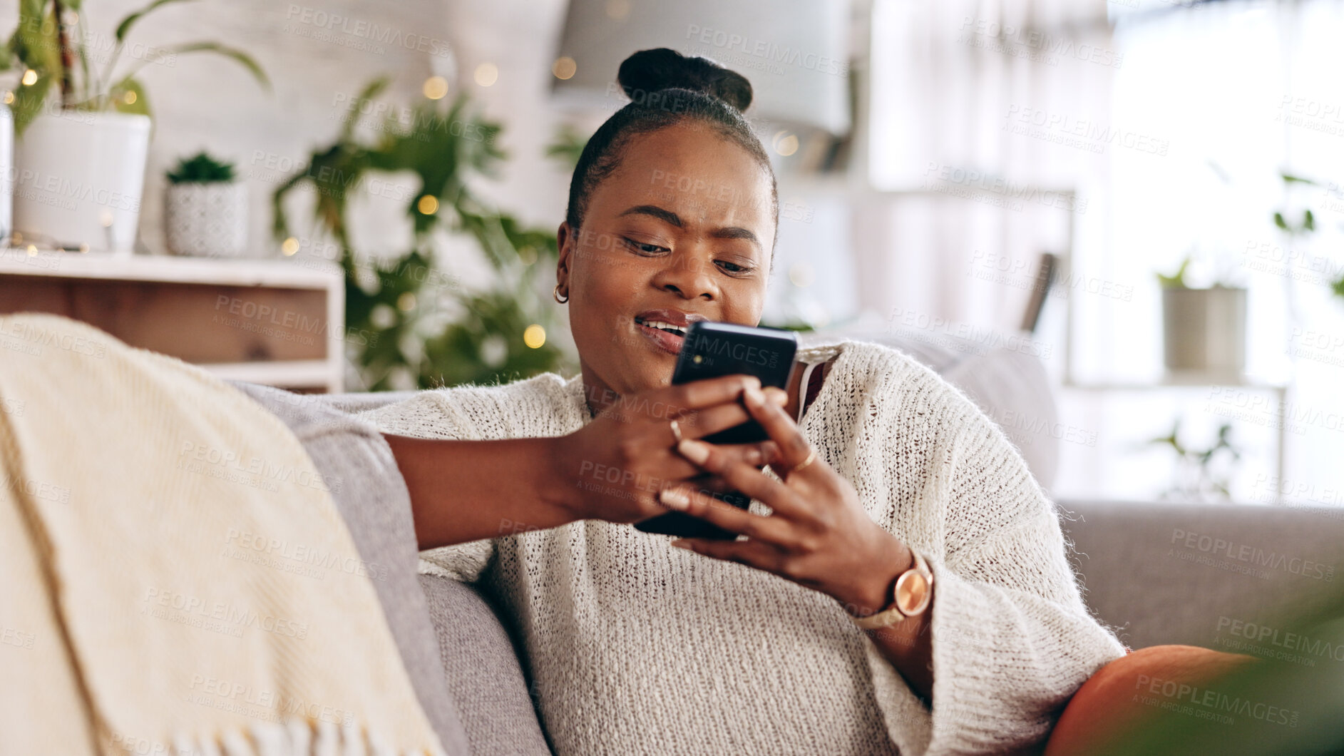 Buy stock photo Black woman, relax and typing on smartphone on sofa, reading social media post and contact chat at home. Mobile, app and download digital games, scroll technology or multimedia notification in lounge