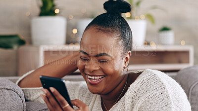 Phone, happy and black woman on a sofa with social media, joke or online comic in her home. Internet, meme and female relax in a living room while reading, browsing and enjoy streaming subscription